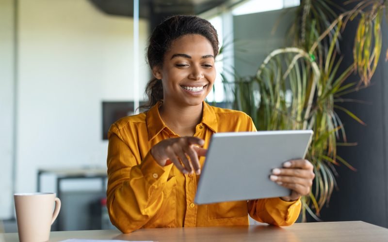 modern-technologies-in-business-happy-black-businesswoman-using-modern-digital-tablet-working.jpg